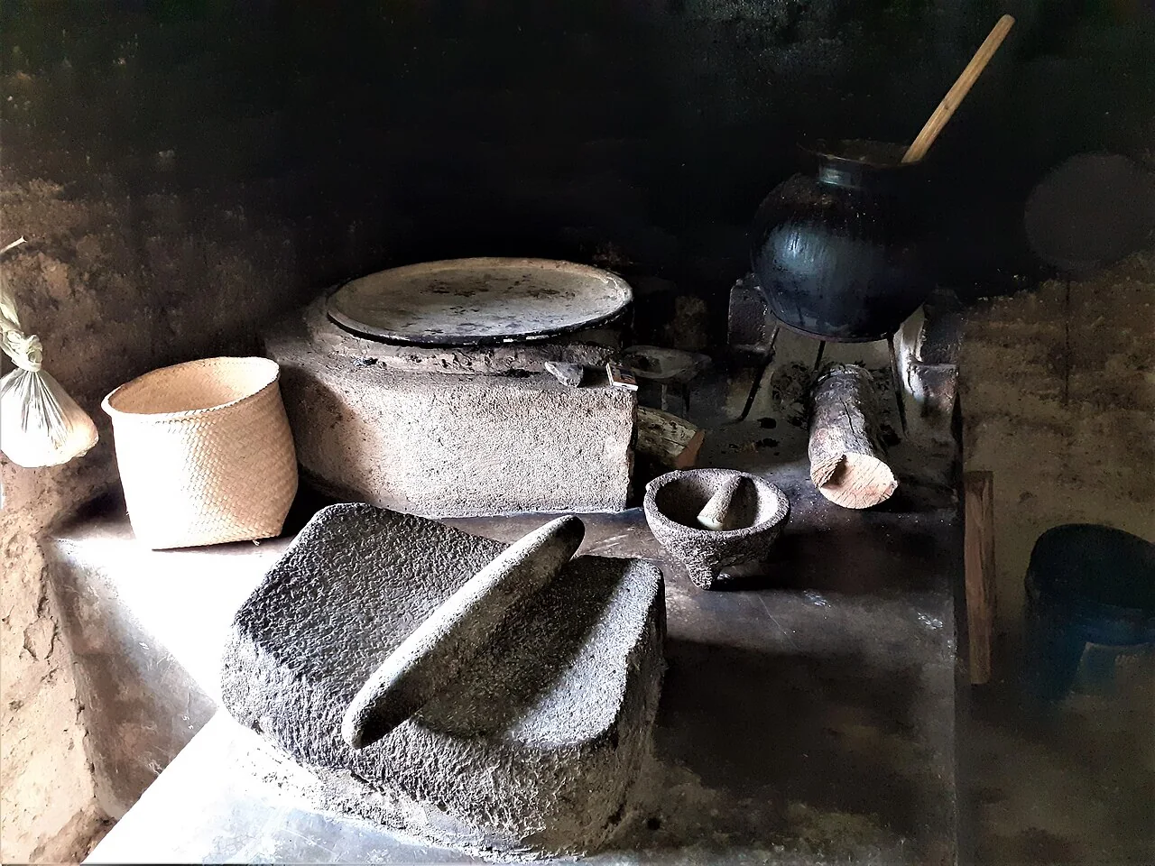 Metate, comal y utensilios en una cocina tradicional.